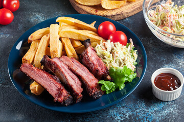 Spicy barbecued pork ribs served with french fries