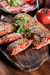 Italian stromboli stuffed with ham, salami and cheese