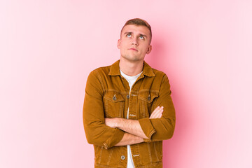 Young caucasian man isolated tired of a repetitive task.