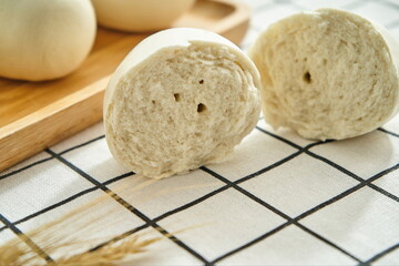 Steamed steamed bread after breaking apart on the wooden tray close-up