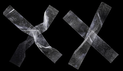 sets of transparent sticky tapes forming the letter x or overlapping each other on black...