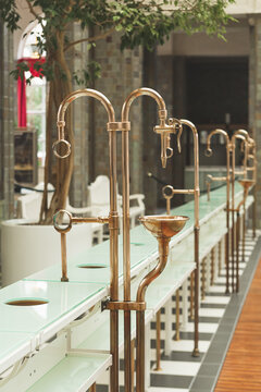 The copper pipes and faucets for mineral waters in the Fountain Hall of the Wandelhalle in Bad Kissingen, Germany