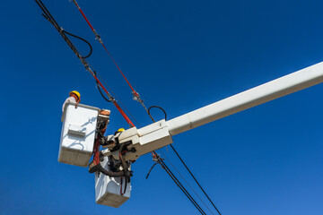 maintenance of electricians work with high voltage electricity on the hydraulic bucket
