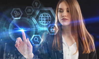 Business, Technology, Internet and network concept. Young businessman working on a virtual screen of the future and sees the inscription: Implementation