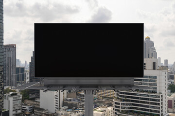 Blank black road billboard with Bangkok cityscape background at day time. Street advertising poster, mock up, 3D rendering. Front view. The concept of marketing communication to promote or sell idea.