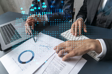 Man and woman working together on international business project. Blue infographic hologram of planet earth. World map. Multiexposure.