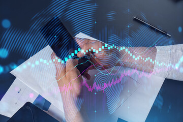 Man using phone. Hands typing smartphone. Double exposure with forex graph hologram. Close up. Financial chart and analysis concept. On-line trading and investment.