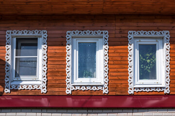Vintage architecture facade new wooden house. Gingerbread trims frame windows.