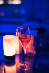 Champagne in glass on backdrop of night pub