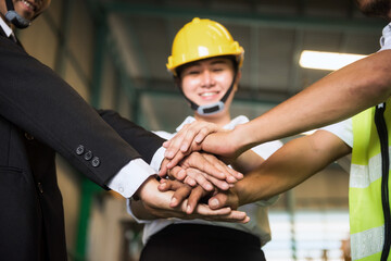 Happy teamwork. Stack hands together in factory