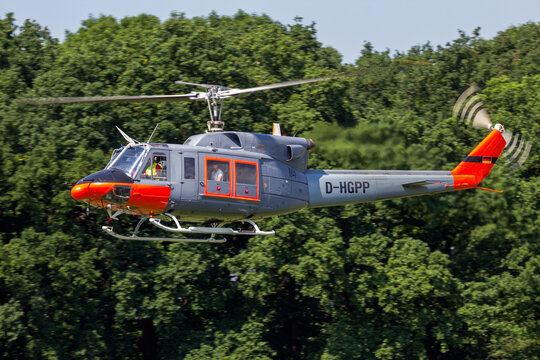 Bell 212 Huey twin-engine utility helicopter helicopter about to land. AHLEN, GERMANY - JUN 5, 2016