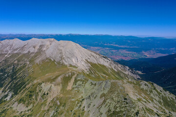 Amazing beautiful alpine valley and mountain peak.  Wild nature, summer, blue sky.
