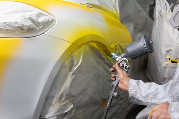 Auto body repair series: Yellow sports car being repaint
