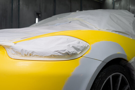 Auto body repair series: Yellow sports car being repaint