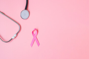 Breast Cancer Awareness, Pink Ribbon with Stethoscope on pink background for supporting people living and illness. Woman Healthcare and World cancer day concept