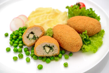 Chicken cutlets in bread crumbs stuffed with butter and herbs