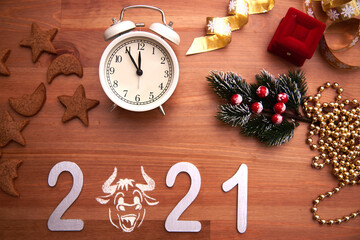 Obraz na płótnie Canvas new year's layout for a calendar and greeting card on a wooden background. The year symbol is a Bull between the digits.The view from the top.
