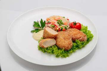 Chicken cutlets in batter with risotto and vegetables