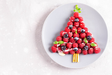Christmas food art. Raspberry berry christmas tree, top view. Copy space