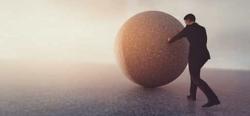 Businessman pushing heavy rock. © Photocreo Bednarek