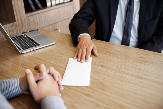 Businessman giving resign letter to his manager for quit a job.