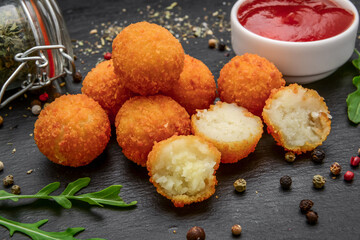 fried cheese ball on a wooden plate