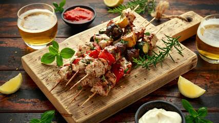 Chicken kebab, BBQ, skewers with mushrooms, red sweet pepper, zucchini and beer. Party food