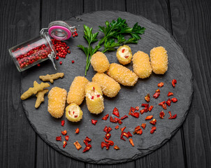 fried cheese ball on a wooden plate