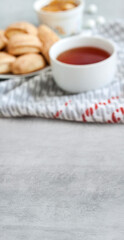 Tasty breakfas. Banner with copy space and cup of tea with sweet cinnamon cookies on background. Shallow depth