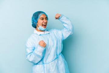 Young surgeon asian woman isolated raising fist after a victory, winner concept.