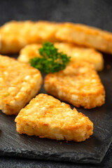 Hash brown potato patties on rustic stone board
