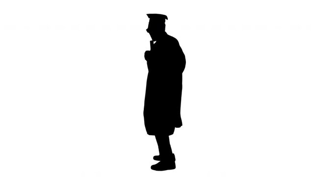 Silhouette Excited african american male student in graduation robe dancing happily with his diploma.