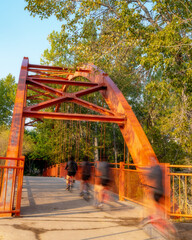 Bike rider motion blur crossing a bridge