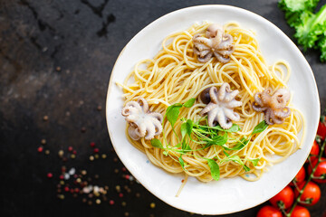 spaghetti pasta baby octopus seafood fresh second course on the table tasty serving size portion top view copy space for text food background rustic
