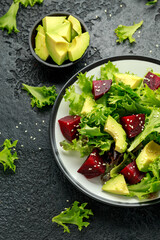 Vegetarian avocado and beet salad in plate. Healthy vegan food