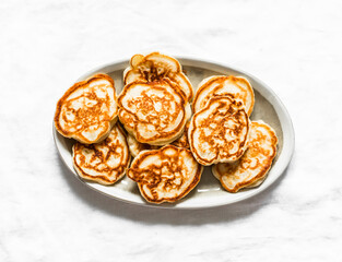 Simple pancakes on a light background, top view. Delicious breakfast, dessert, snack