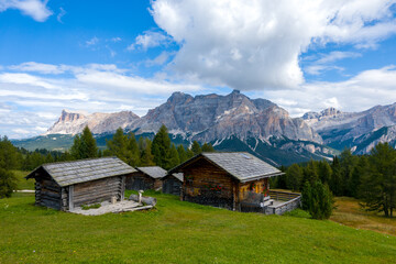 Fototapeta na wymiar Hut and Piz de Medesc (Medesspitze) and Cima Cunturines (Cunturines-Spitze) beautiful panorama landscape of the dolomites mountains, alpes south tyrol Italy