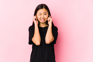 Young asian woman wearing elegant clothes isolated covering ears with hands.