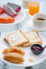 Breakfast. Happy Morning with bread and jam, fresh fruits, orange juice and a cup of coffee.