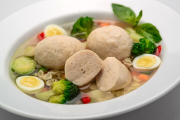 Hot chicken soup with vegetables,, broth with meatballs
