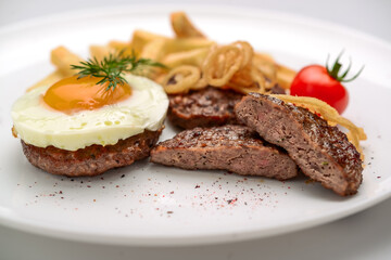 Beef rissole, juicy beef steak with egg and potatoes