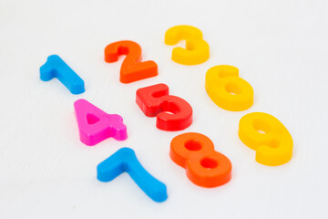 Kids plastic numeral on white background. Study counting with fridge magnets. Education in preschool and primary school