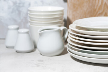 Fototapeta na wymiar clean tableware, cutlery and kitchen utensils on white background, closeup