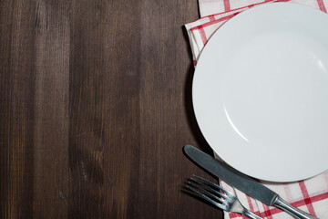 empty plate and cutlery, wooden background for recipes