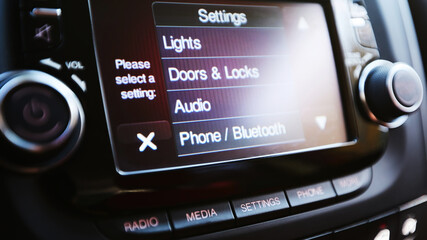 Modern luxury car interior. Touch Screen monitor with settings. Shallow dof