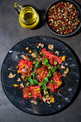 fresh beef carpaccio with capers and arugula, vertical