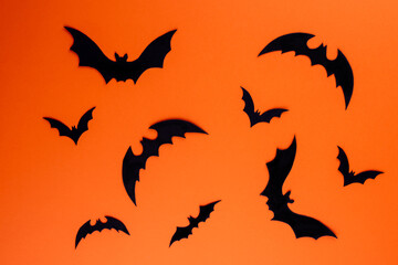 Black paper bats on horizontal orange background
