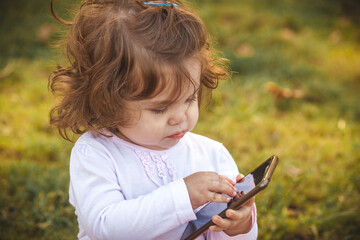 baby with mobile in park