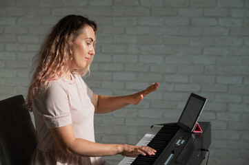Female singing teacher at online lesson on digital tablet