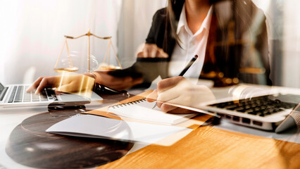 Business and lawyers discussing contract papers with brass scale on desk in office. Law, legal services, advice, justice and law concept picture with film grain effect